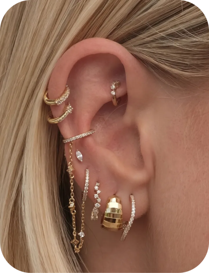 Curated ear with gold hoops and studs previewed with PiercingAI