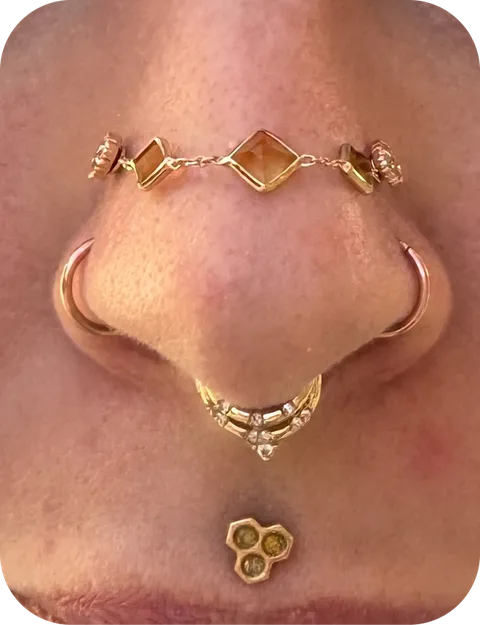 Nose piercing preview with gold jewelry